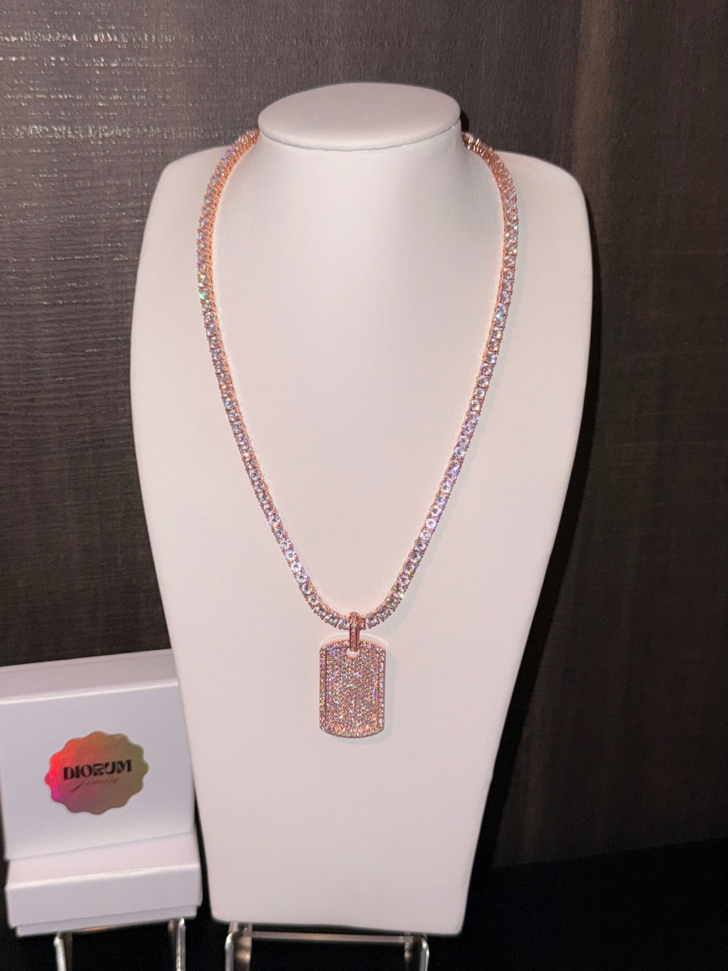White gold plated tennis necklace and iced tag pendant.