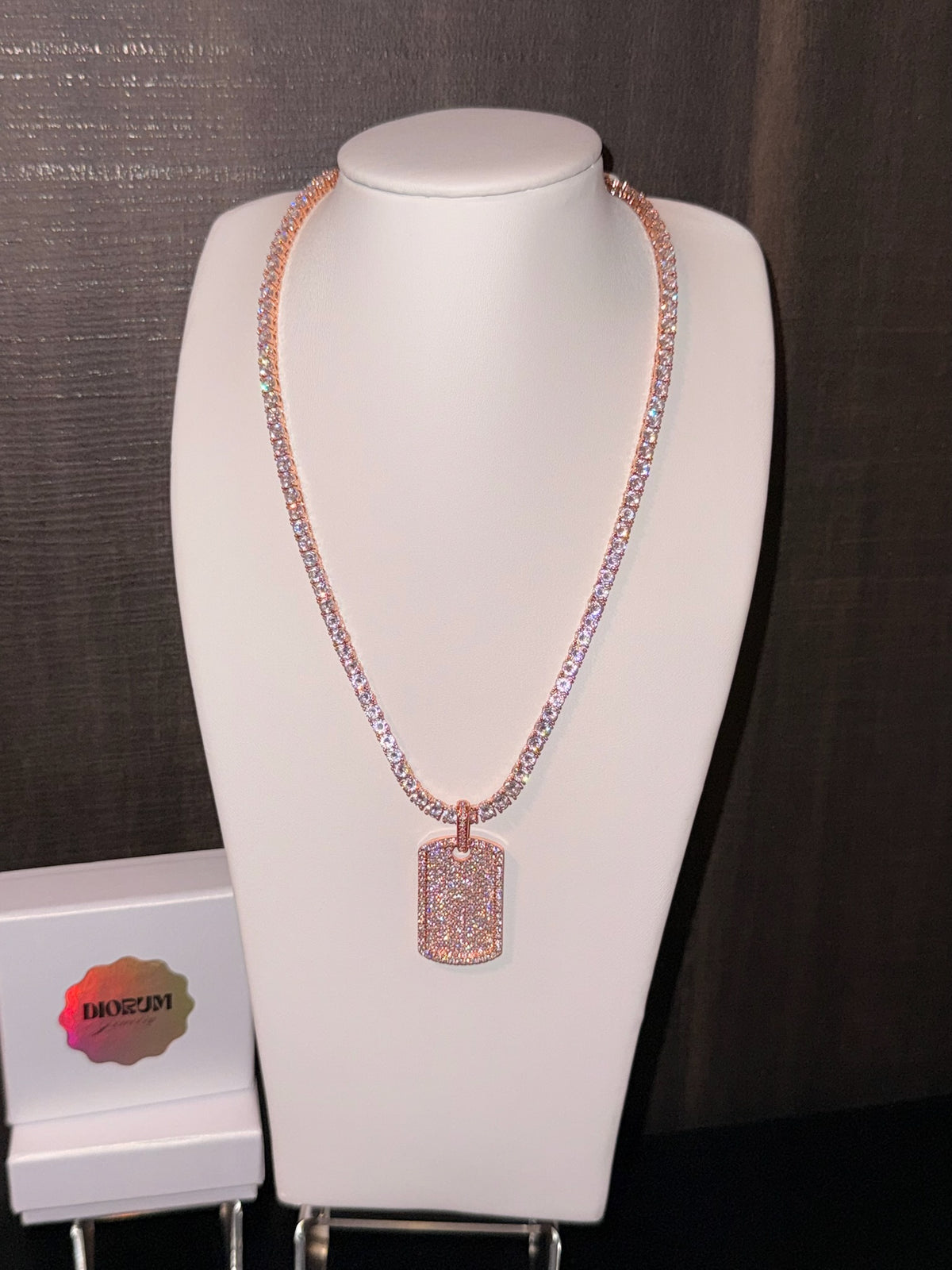 White gold plated tennis necklace and iced tag pendant.