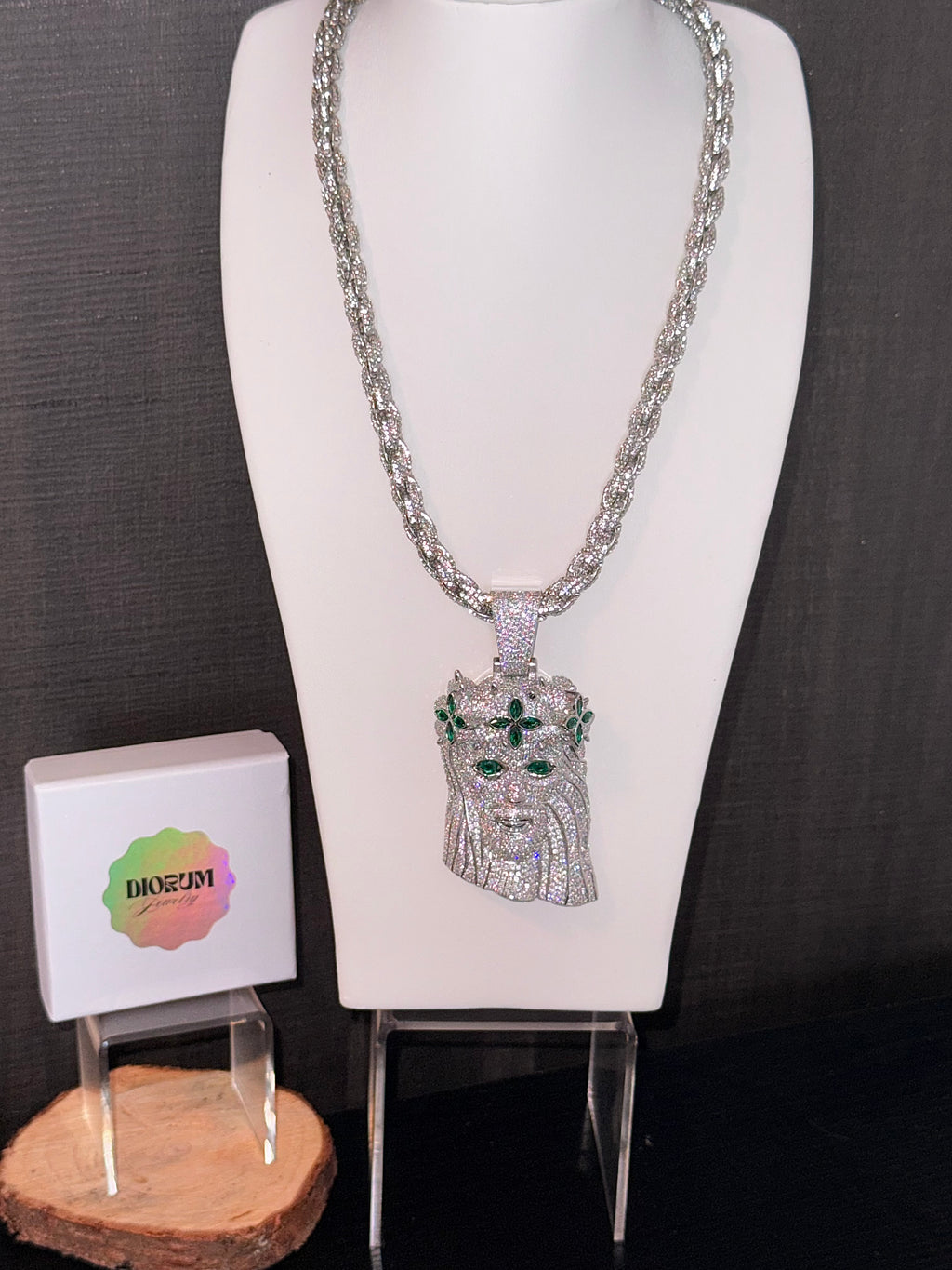 White gold plated iced rope chain and god face pendant.