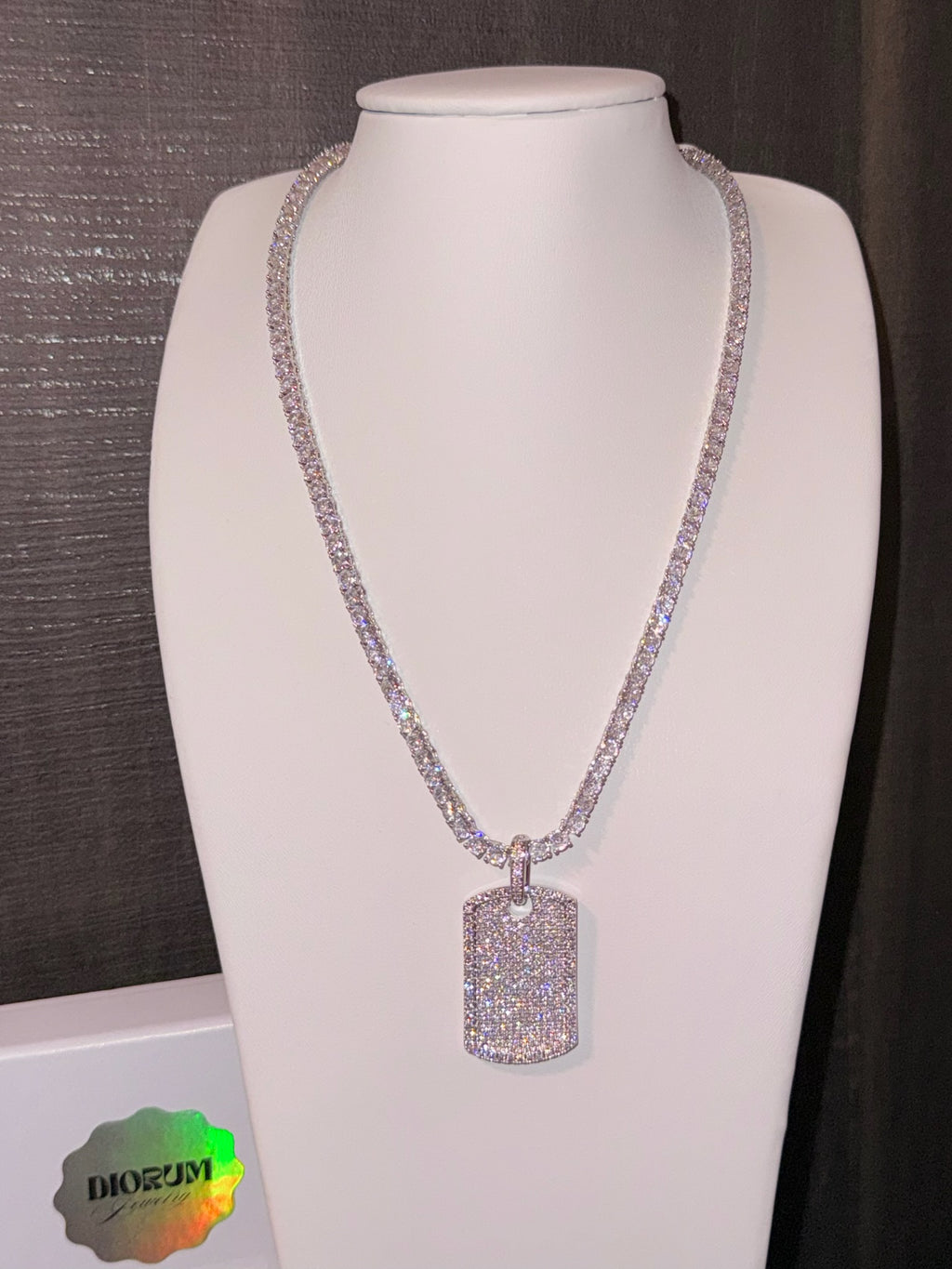 White gold plated tennis necklace and iced tag pendant.