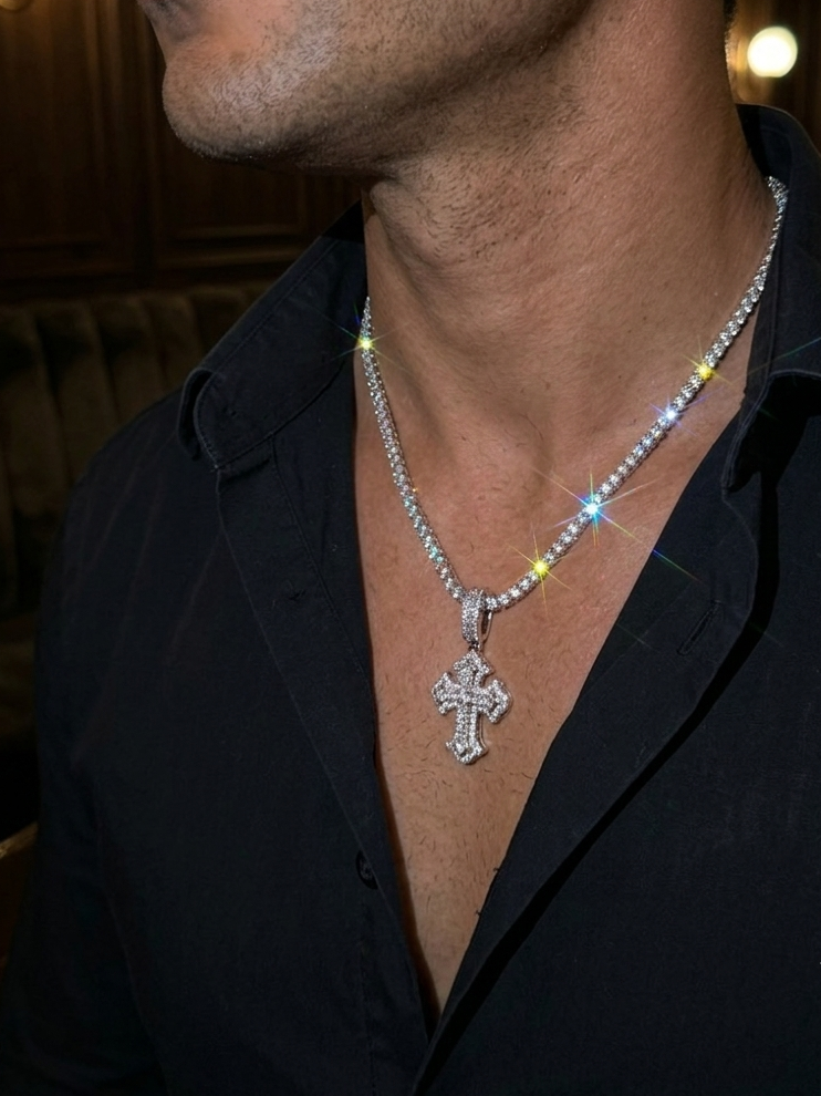 White gold plated tennis chain and iced cross pendant.