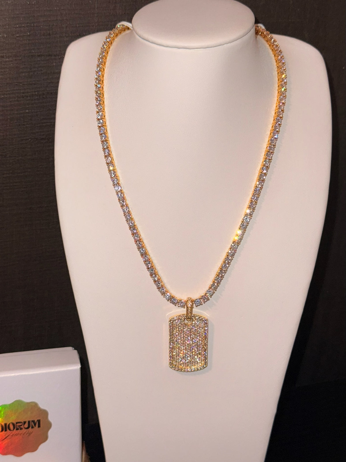 White gold plated tennis necklace and iced tag pendant.