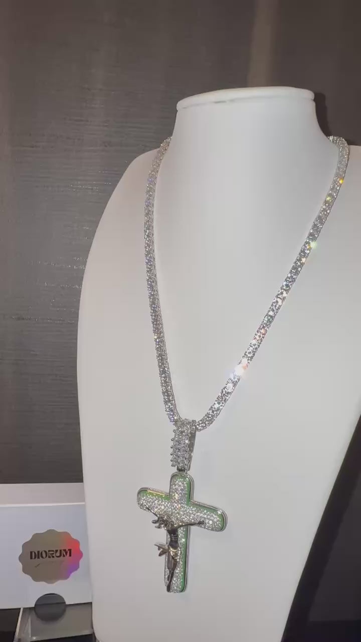 White gold plated tennis chain and icy cross pendant.