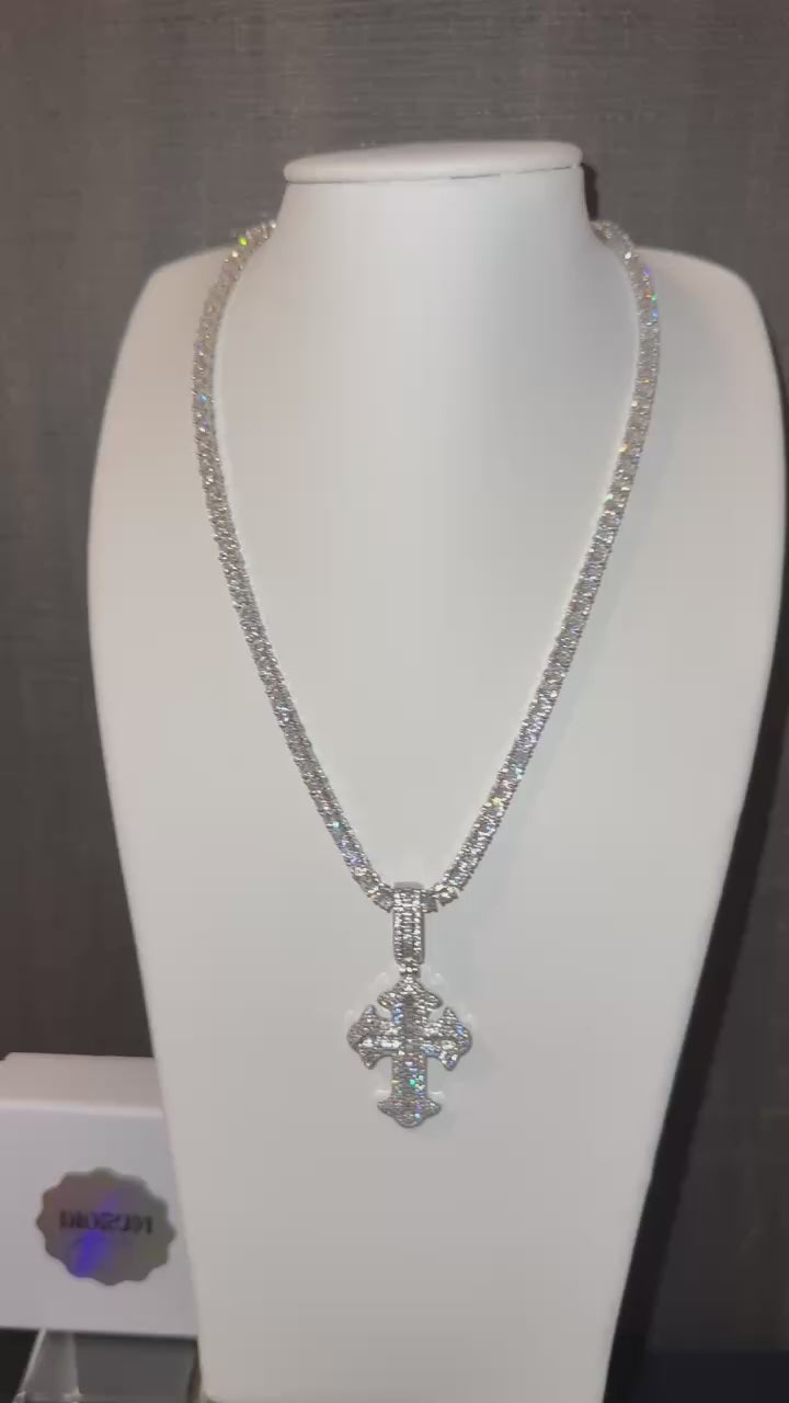 White gold plated tennis chain and iced cross pendant.